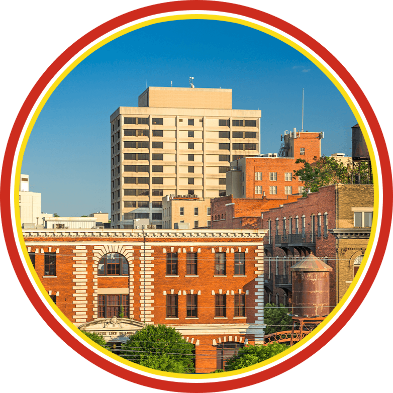 Circular logo with a city building scene inside a red-yellow border