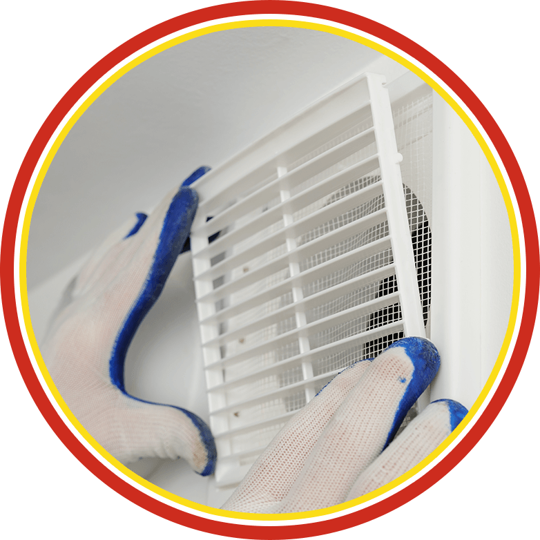 Gloved hands cleaning a white vent cover with a brush and cloth.